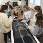 AN INSIDE LOOK: Margaret Morrissey-Basler, assistant professor of health sciences, second from left, instructs students in an anatomy class at Providence College. Traditionally, liberal arts colleges are putting more emphasis on professional majors, such as the nursing program at PC, as interest has grown.  PBN PHOTO/MIKE SKORSKI