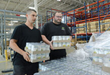 High food costs still difficult to digest in R.I. HEAVY LIFTING: Joe Parillo, left, warehouse expeditor, and Joe Regan, warehouse manager, unload cases of canned goods at the Rhode Island Community Food Bank’s distribution center in Providence.
PBN PHOTO/ELIZABETH GRAHAM