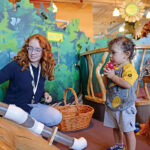 PLAYTIME: Jordan Towle, a visitor services manager at the Providence Children’s Museum, plays with Jorge Rodrigues, 1, of Providence. The museum, according to Executive Director Caroline Payson, relies on ticket sales and membership fees to bolster operating costs.  PBN PHOTO/ELIZABETH GRAHAM