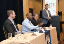Firms hesitating on AI are falling behind, PBN summit panel says FUTURE SHOCK: Arnell Milhouse, second from right, founder and CEO of CareerDevs Inc., speaks during the PBN Cybersecurity & Tech Summit on Oct. 12. Milhouse sees massive changes coming because of artificial intelligence, but many of the changes will be positive, he says. With Milhouse on the panel are Jeffrey Wilhelm, left, founder and CEO of Infused Innovations Inc., and Timothy Henry, seated right, assistant professor and researcher at Rhode Island College. Christopher Parisi, standing, founder and president of marketing firm Trailblaze Inc., moderates.
PBN PHOTO/MIKE SKORSKI