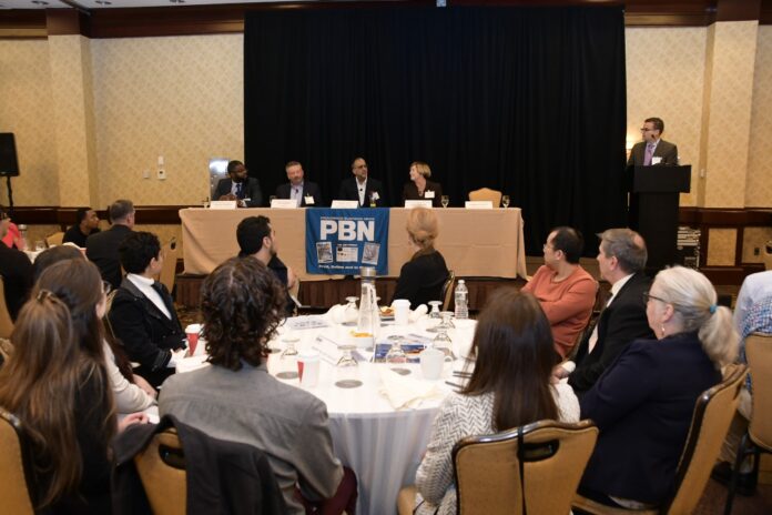 NORMAND DUQUETTE, far right, senior vice president if Starkweather & Shepley Insurance Brokerage Inc., moderates the opening panel during the PBN Cybersecurity and Tech Summit at the Crowne Plaza Providence-Warwick on Thursday. He is joined by, from left, Douglas Tondreau, associate professor of computer science at Johnson & Wales University; Rick Norberg, CEO of Vertika6; Robby Gulri, a solutions engineering leader at RapidScale, Cox Communications subsidiary; and Linn F. Freedman, attorney and chair of data privacy and cybersecurity at Robinson & Cole LLP. / PBN PHOTO/MIKE SKORSKI