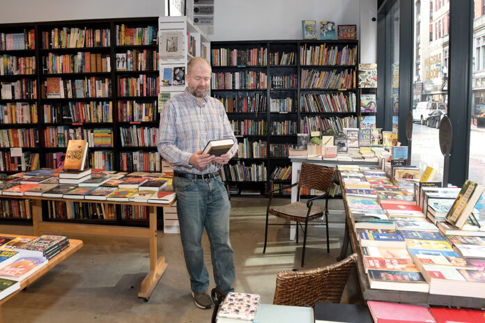 RELIEVED: Scott McCullough, co-owner of Symposium Books Inc. in Providence, is happy he won’t have to pay a tangible property tax, thanks to legislation passed by state legislators that exempts businesses from the first $50,000 they would typically owe in tangible taxes.  PBN PHOTO/MIKE SKORSKI