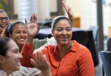 Closing R.I.’s language gap in behavioral health care SHOW OF HANDS: Rhode Island College social work student Julianna Alcantra, center, participates in the welcome event held by Atrévete Center of Excellence for Latinx/Hispanic Social Work Practice at the start of the fall semester. With her is, from the foreground, fellow students Vanessa Sanchez, Olivia Campos and Crissany Nazario.
COURTESY RHODE ISLAND COLLEGE
