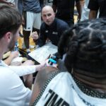 PHIL MARTELLI JR., center, has been named Bryant University's new head men's basketball coach. He was an interim coach when Jared Grasso, who has since resigned, was suspended by the university back in late September. / COURTESY BRYANT UNIVERSITY