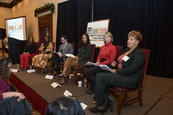 CHRISTIN ZOLLICOFFE, far right, vice president of chief belonging and equity officer at Lifespan Corp., speaks during Providence Business News’ 2023 Diversity, Equity and Inclusion Summit and Awards program on Thursday. Also on the panel are, from right, Amy Walsh, executive director of commercial banking and diverse business regional executive for JPMorgan Chase & Co.; Jenny Bautista Ravreby, Blue Cross & Blue Shield of Rhode Island diversity, equity, and inclusion manager; Kevin Matta, board president for Diversity and Inclusion Professionals and senior director of people & culture for United Way of Rhode Island Inc.; Talia Brookshire, Neighborhood Health Plan of Rhode Island’s chief diversity officer; and Shameen Awan, vice president of talent management and DE&I assistant vice president at Amica Mutual Insurance Co. / PBN PHOTO/MIKE SKORSKI