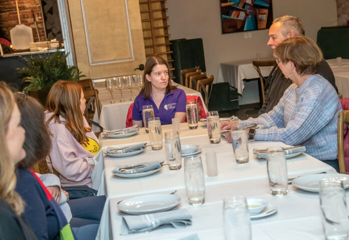 TWO-FOR-ONE: Providence Tour Co. guide Kate Kelly, center, leads a Crime Cuisine Tour at Trattoria Appia on Federal Hill in Providence. At right are two of the dozen or so attendees, Tom and Marylou Costello, of Franklin, Mass. PBN PHOTO/MICHAEL SALERNO