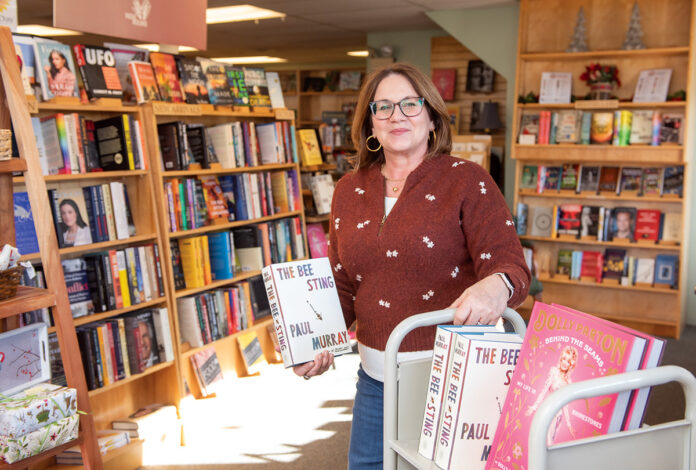 TURNING THE PAGE: Laurie Sutherland says she always wanted to own her own bookstore, so when she saw an online ­advertisement for the sale of Island Books in Middletown, she visited the store, fell in love with it and bought the store.  PBN PHOTO/DAVID HANSEN