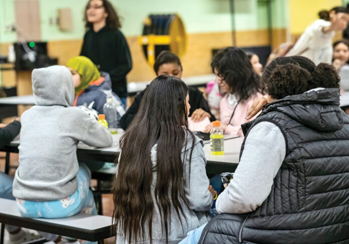 MEAL TIME: ­Students at Nathanael Greene Middle School in Providence eat lunch in the school’s cafeteria.  Providence Public School District schools have offered breakfast and lunch at no charge since 2019 under the federal Community Eligibility Provision.  PBN PHOTO/MICHAEL SALERNO