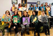 ATTENDEES HOLD PORTRAITS at a recent Rhode Island Vegan Awareness painting fundraising event. The organization will hold a Paint & Sip Fundraiser on Feb. 24 at Plant City in Providence. / COURTESY RHODE ISLAND VEGAN AWARENESS