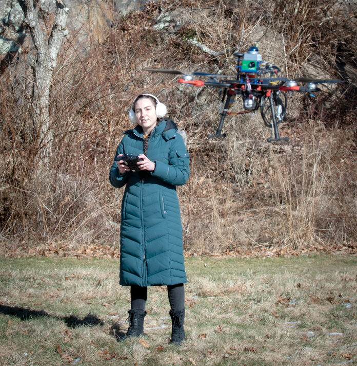 TEST FLIGHT: Erin Linebarger flies a prototype robotic drone in Newport. The drone was developed by Robotics 88 Inc., the company she co-founded with Tyler Lane to assist with prescribed fire planning, which involves controlled burns to remove dead and harmful vegetation to prevent the spread of wildfires and allow for new growth.
PBN PHOTO/DAVID HANSEN TEST FLIGHT: Erin Linebarger flies a prototype robotic drone in Newport. The drone was developed by Robotics 88 Inc., the company she co-founded with Tyler Lane to assist with prescribed fire planning, which involves controlled burns to remove dead and harmful vegetation to prevent the spread of wildfires and allow for new growth.
PBN PHOTO/DAVID HANSEN