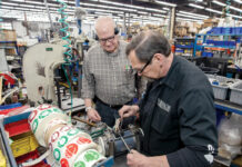 GOING STRONG:  John Vitko, left, customer service, and assembly worker George Durfee are part of an older workforce that manufacturer VIBCO Inc. continues to rely heavily on, according to CEO Karl ­Wadensten.  PBN PHOTO/ TRACY JENKINS