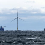 ON THE HORIZON: Ships get into position in December to finish building turbines for South Fork Wind, 15 miles east of Block Island. The wind farm is now operational and providing power for New York.  AP FILE PHOTO/JULIA NIKHINSON