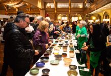 ATTENDEES OBSERVE a collection of bowls during the Rhode Island Community Food Bank's Empty Bowls fundraiser in 2019. The Empty Bowls fundraiser returns March 27 at the WaterFire Arts Center in Providence. / COURTESY RHODE ISLAND COMMUNITY FOOD BANK