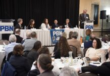 SEN. PAMELA J. LAURIA, third from left, speaks during a panel discussion at Providence Business News' Health Care Summit and Health Care Heroes Awards event at the Providence Marriott on April 4. Also on the panel are, from left, Dr. Michael Wagner, Care New England Health System CEO; Dr. Kristin Russell, Neighborhood Health Plan of Rhode Island chief medical officer; Dr. Raj Hazarika, Point32Health Services Inc. chief medical officer and vice president of commercial products; and Joan Kwiatkowski, PACE Organization of Rhode Island CEO. PBN Editor Michael Mello, standing at right, moderates. / PBN PHOTO/MIKE SKORSKI