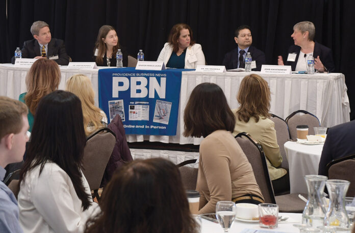 HEALTHY DISCUSSION: PACE Organization of Rhode Island CEO Joan Kwiatkowski, right, speaks during a panel discussion at Providence Business News’ Health Care Summit and Health Care Heroes Awards event at the Providence Marriott on April 4. Also on the panel are, from left, Dr. Michael Wagner, Care New England Health System CEO and president; Dr. Kristin Russell, Neighborhood Health Plan of Rhode Island chief medical officer; Sen. Pamela J. Lauria, D-Barrington; and Dr. Raj Hazarika, Point32Health Services Inc. chief medical officer and vice president of commercial ­products.  PBN PHOTO/MIKE SKORSKI