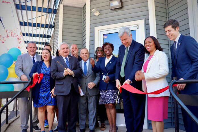 RHODE ISLAND BLACK BUSINESS Association Founder, CEO and President Lisa Ranglin, center, along with local city, state and federal leaders cut the ribbon Tuesday on the association's new headquarters at 220 Smith St. in Providence. / COURTESY SEN. JACK REED, D-R.I.