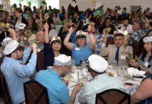 FALVEY INSURANCE GROUP employees wear sailor hats on Thursday during the festive Providence Business News 2024 Best Places to Work Awards ceremony at the Crowne Plaza Providence-Warwick. / PBN PHOTO/MIKE SKORSKI