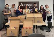 FEEDING THE NEEDY: Employees at Hinckley, Allen & Snyder LLP pack up food donations to help those in need within Rhode Island.  COURTESY HINCKLEY, ALLEN & SNYDER LLP