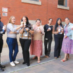 TASTY TREATS: Employees at R.I. Housing and Mortgage Finance Corp. enjoy ice cream outside their office.  COURTESY R.I. HOUSING AND MORTGAGE FINANCE CORP.