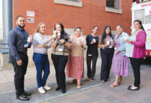 R.I. Housing and Mortgage Finance Corp. TASTY TREATS: Employees at R.I. Housing and Mortgage Finance Corp. enjoy ice cream outside their office.
COURTESY R.I. HOUSING AND MORTGAGE FINANCE CORP.