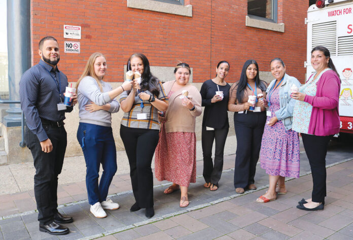 TASTY TREATS: Employees at R.I. Housing and Mortgage Finance Corp. enjoy ice cream outside their office.
COURTESY R.I. HOUSING AND MORTGAGE FINANCE CORP. TASTY TREATS: Employees at R.I. Housing and Mortgage Finance Corp. enjoy ice cream outside their office.
COURTESY R.I. HOUSING AND MORTGAGE FINANCE CORP.