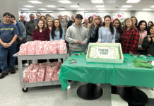 Swarovski Optik North America SNACK TIME: Swarovski Optik North America Ltd. employees gather for cake and popcorn.
COURTESY SWAROVSKI OPTIK NORTH AMERICA LTD.
