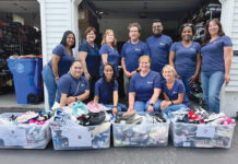 A SHOE-IN: The Beacon Mutual Insurance Co. employees collect shoes for Gotta Have Sole during the company’s Employee Volunteer Week.  COURTESY THE BEACON MUTUAL INSURANCE CO.