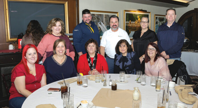 DINNER TIME: Staffers at The Providence Mutual Fire Insurance Co. enjoy a dinner outing together.  COURTESY THE PROVIDENCE MUTUAL FIRE INSURANCE CO.