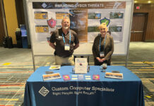 ON DISPLAY: From left, Custom Computer Specialists Inc. employees Mason Sock and Suzanne McLaughlin work an informational stand on how to manage cyberthreats at a recent showcase event.  COURTESY CUSTOM COMPUTER SPECIALISTS