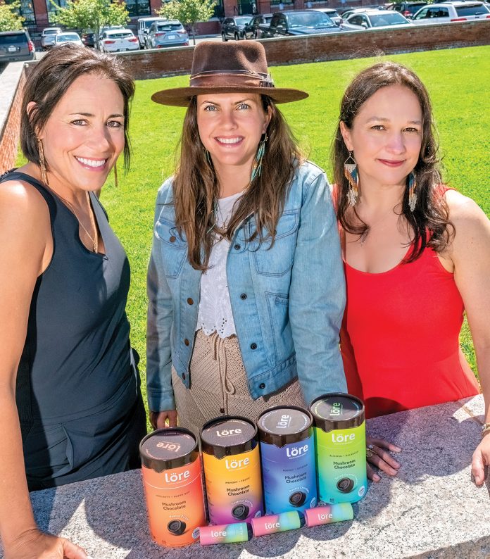 FOOD THAT FUNCTIONS: Lore Mighty Mushrooms co-founders, from left, CEO Hope Parish, Kyleen Keenan and Robin Robinson, with some of their mushroom-based health/well- ness supplement products.  PBN PHOTO/MICHAEL SALERNO