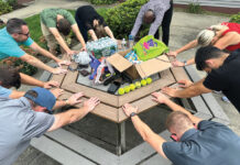 New England Construction STRETCHING OUT: Employees at New England Construction Inc. stretch before a competitive team-building game.
COURTESY NEW ENGLAND CONSTRUCTION INC.