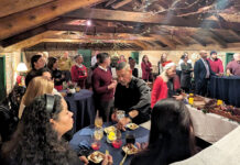 Partridge Snow & Hahn LLP GOOD EATING: Partridge Snow & Hahn LLP employees gather and eat offerings at a recent holiday party.
COURTESY PARTRIDGE SNOW & HAHN LLP