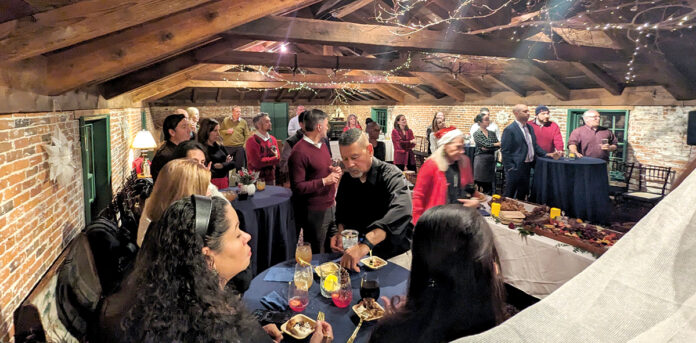GOOD EATING: Partridge Snow & Hahn LLP employees gather and eat offerings at a recent holiday party.
COURTESY PARTRIDGE SNOW & HAHN LLP GOOD EATING: Partridge Snow & Hahn LLP employees gather and eat offerings at a recent holiday party.
COURTESY PARTRIDGE SNOW & HAHN LLP