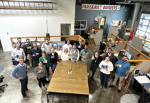 Pariseault Builders Inc. MUG SHOT: Employees at Pariseault Builders Inc. hold a “silly mug” swap during a recent company holiday event.
COURTESY PARISEAULT BUILDERS INC.