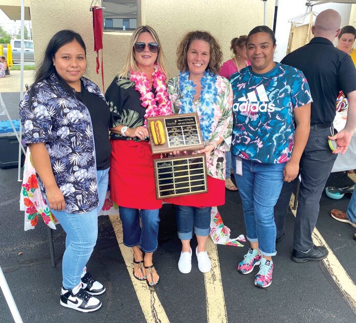 DOGGED DETERMINATION: Greenwood Credit Union employees celebrate a win during the 2023 Hot Dog Day event.
COURTESY GREENWOOD CREDIT UNION DOGGED DETERMINATION: Greenwood Credit Union employees celebrate a win during the 2023 Hot Dog Day event.
COURTESY GREENWOOD CREDIT UNION