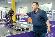 ROBOTS RISING? Manufacturers mull employing tech as it gets smarter, cheaper CO-BOT CONVERSATION: Mike Rielly, head of public relations at igus Bearings Inc. in East Providence, discusses one of the robots that the company produces, which are known as collaborative robots, or co-bots, along with other automation technology that it sells to manufacturers.
PBN PHOTO/MICHAEL SALERNO