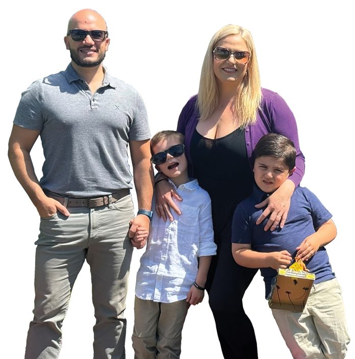 the prop Daniel Pereira poses with his wife, Kristen, and their two children, Elliott, 6, and Wyatt, 5.