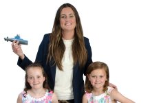Katie Delehanty the prop Katie Delehanty poses with her three daughters, Molly, 10, holding a volleyball; Nora, 8, holding a basketball; and Rosie, 5, holding a Barbie.