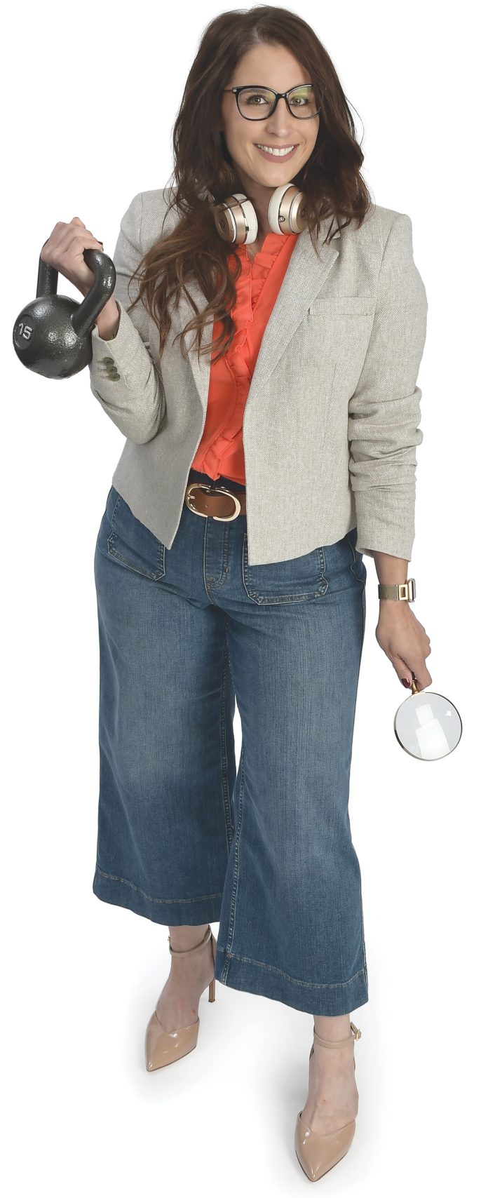 the prop  Aimee Fennessey holds a kettle bell, symbolizing her love for exercise, headphones and a magnifying glass, symbolizing the internal audit profession.