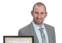 Alex Finkelman the prop
Alex Finkelman holds a framed insurance policy written by his great-grandfather insuring $5,000 of whiskey and gin from the prohibition era.