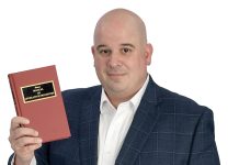 the prop  Steve Iannazzi holds the Mason’s Manual of Legislative Procedure, the rulebook for how legislative bodies operate.