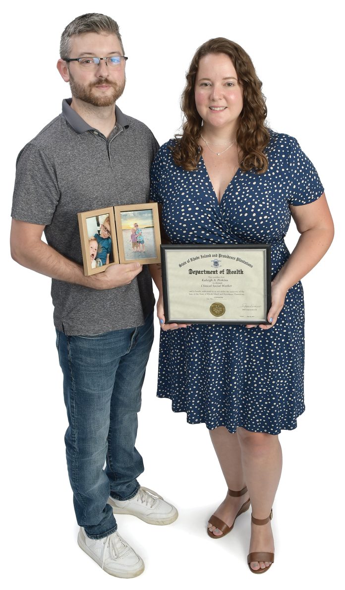 the prop  Kaleigh Perkins poses with her fiancé, Eric, pictures of her two children, Sylas and Wyatt, and her clinical social worker license.