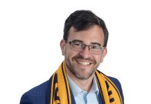 the prop  Dylan Zelazo wears a Rhode Island FC scarf.  “[It] represents me personally because I have  season tickets and attend every home game  with my kids and my parents,” he said.