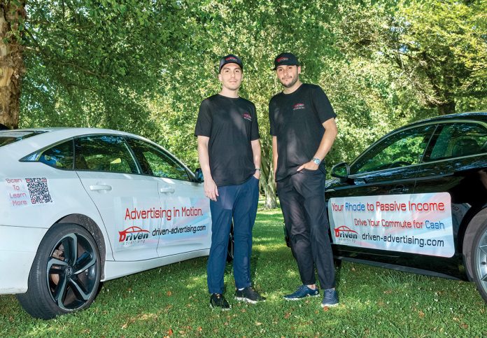 ADS IN MOTION: Driven Advertising LLC owners Kyle Johnson, left, and Brandon Maselli sell ad space on people’s cars who are looking for side income.
PBN PHOTO/MICHAEL SALERNO ADS IN MOTION: Driven Advertising LLC owners Kyle Johnson, left, and Brandon Maselli sell ad space on people’s cars who are looking for side income.
PBN PHOTO/MICHAEL SALERNO