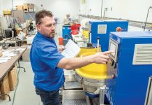 Finishing with a flourish SHOWING OFF: Steven Alviti Jr., Bel Air Finishing Supply Corp. vice president and sales manager, demonstrates one of the company’s machines that deburr and polish intricate parts.
PBN PHOTO/MICHAEL SALERNO