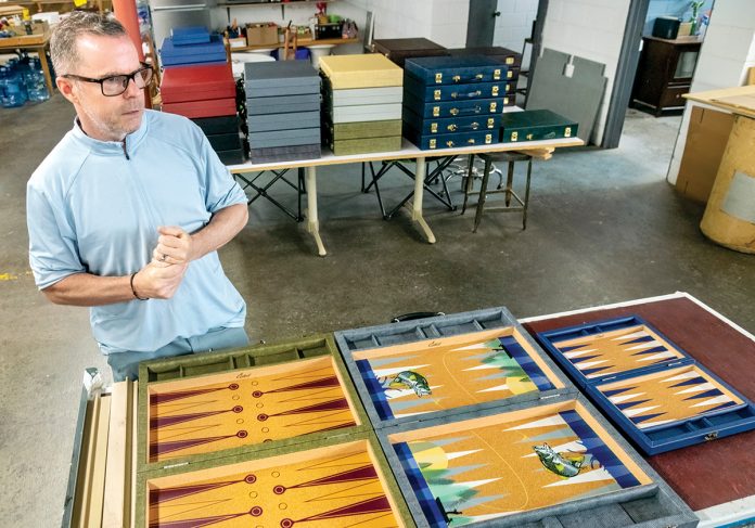 BEAUTIFUL BOARDS: Crisloid Inc. owner Jeff Caruso shows off some of the company’s backgammon game boards.
PBN PHOTO/MICHAEL SALERNO BEAUTIFUL BOARDS: Crisloid Inc. owner Jeff Caruso shows off some of the company’s backgammon game boards.
PBN PHOTO/MICHAEL SALERNO