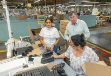 Staying afloat against overseas competition THE END RESULT: International Packaging Corp. CEO John Kilmartin, standing right, speaks with employees Vera Cruz, left, and Marybell Berdugo at a station where presentation boxes are packed for shipping.
PBN PHOTO/MICHAEL SALERNO