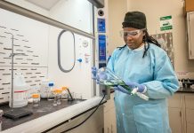 CHEMICAL REACTION: Beatrice Charles of Providence looks at some chemicals while studying in the Community College of Rhode Island’s chemical distillation and processing program at the Westerly Education Center.  PBN PHOTO / MICHAEL SALERNO