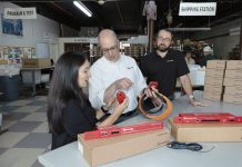 SAFE MONITOR: From left, AVTECH Software Inc. Accounting Manager Raquel Fernandes, Marketing and Channel Manager Russell Benoit and company CEO Rick Grundy review their Room Alert device.  PBN PHOTO / TRACY JENKINS