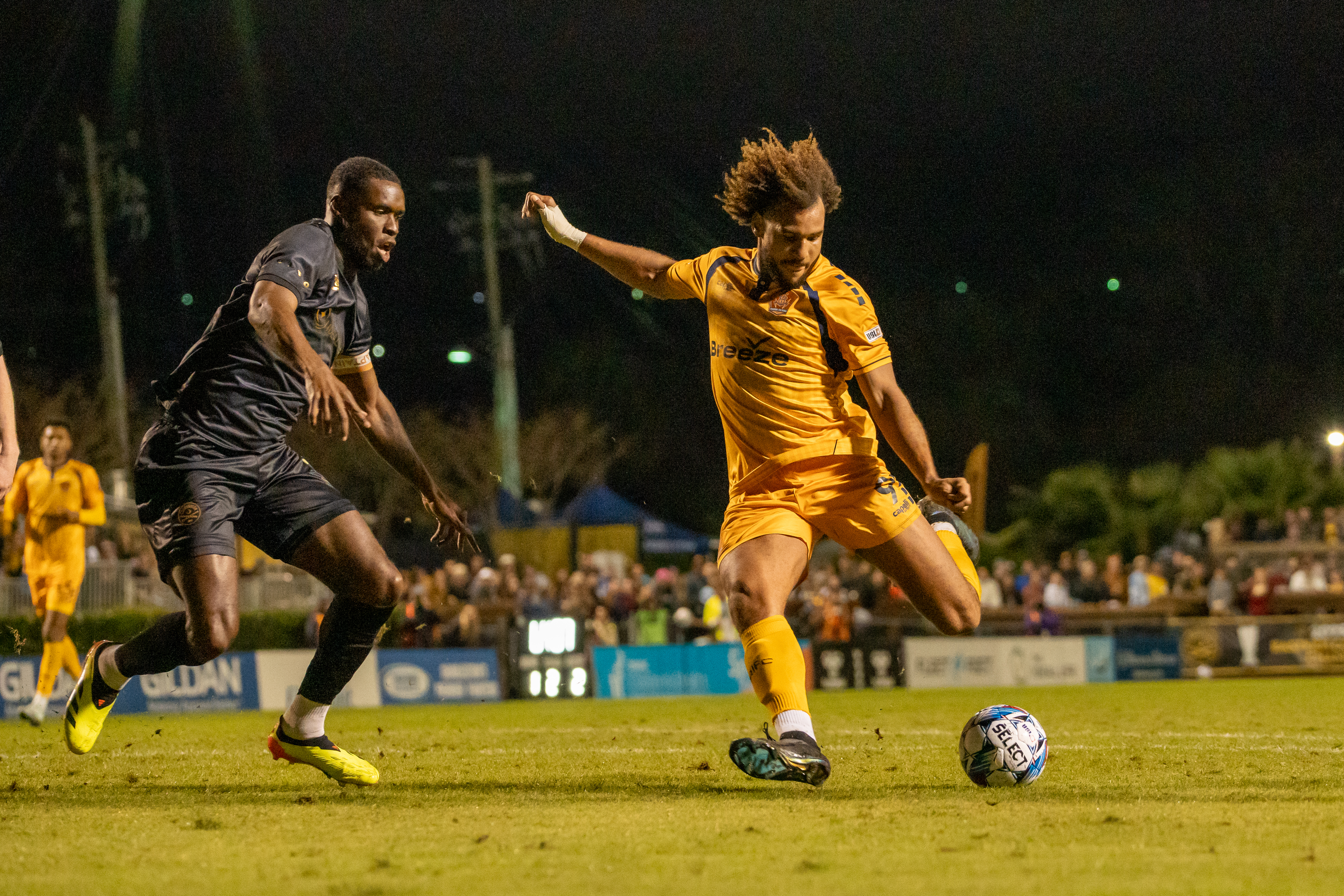 RHODE ISLAND FC forward JJ Williams, right, goes for a kick against a Charleston Battery defender during Rhode Island FC's 2-1 win Nov. 16 in the United Soccer League Championship Eastern Conference Final match. / COURTESY RHODE ISLAND FC